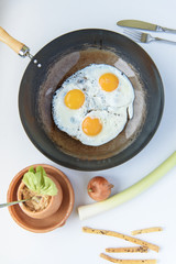 Simple morning breakfast, eggs, leek and breadsticks