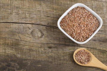 Obraz na płótnie Canvas Organic flax seeds in the bowls - Linum usitatissimum