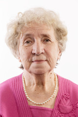 Cute old woman with gray curly hair smiling