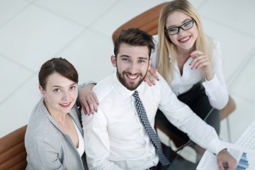 successful business team sitting at table and looking at camera.