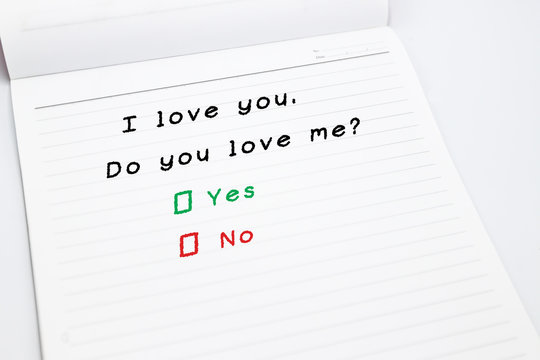 I love you.Do you love me, yes or no written on open lined notebook .The Secret Admirer.Have you ever sent a secret admirer note? White isolation.Easy to use for card.