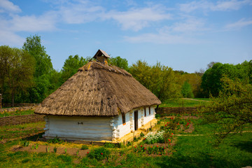 Fototapeta na wymiar small ethnic rural house in a garden