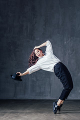 Fototapeta na wymiar Young beautiful female dancer is posing in the studio
