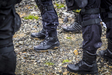 soldiers train shooting with a gun. a group of soldiers are practicing in cold snowy weather. perfectly equipped with equipment and warm military shoes in muddy and dirty weather.