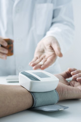 doctor measuring the blood pressure of a patient