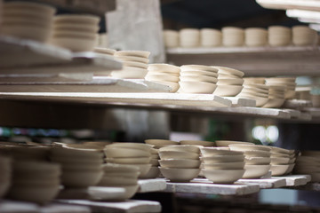 Stack of ceramics bowls on shelf