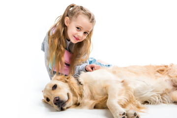 Child and lying dog looking at camera isolated on white
