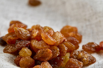 Dried raisins isolated on white background, close-up, macro, shallow depth of field, back light