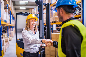 Young warehouse workers working together.