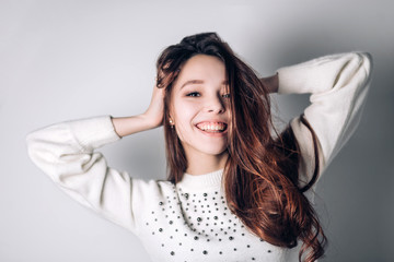 Fototapeta premium Smiling happy woman. Funny young girl on a white background. Sincere positive emotions