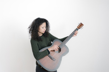 Fototapeta premium Young latin woman with a guitar