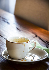 Empty cup of coffee with stains  and cake or cookie crumbs