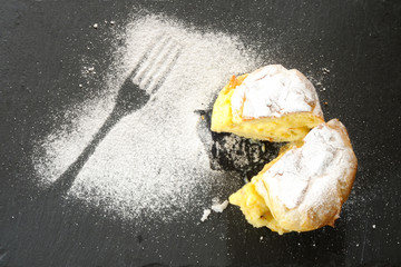 Bigne di San Giuseppe, Saint John's cream puffs, filled with cream and covered with powered sugar, from above
