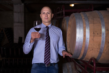 Winemaker inspecting quality of wine