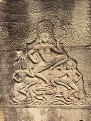 Fototapeta na wymiar Apsara dancers carved on the wall of Khmer ancient temple. Angkor Wat in Siem Reap, Cambodia. 