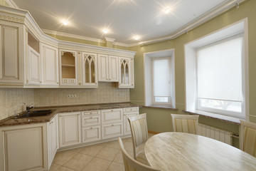 Modern design white kitchen in a spacious apartment.