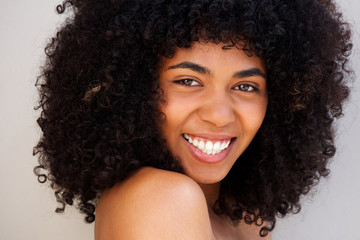 Close up cheerful young african american woman with curly hair