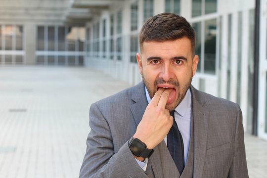 Businessman rejecting something with 	inappropriate hand gesture 