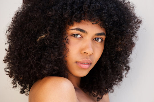 Close Up African American Woman With Curly Hair Against White Background