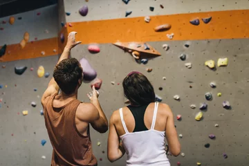 Fotobehang Man and woman at an indoor rock climbing gym © Jacob Lund