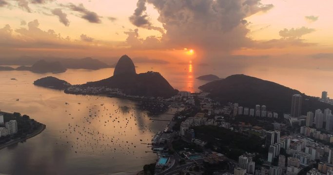 Aerial view of Botafogo Bay and Sugarloaf Mountain at sunrise. Rio de Janeiro, Brazil. Reflection of the rising sun on water
