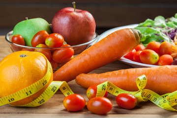Healthy concept with mixed fruits and vegetables on wooden background