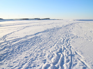 tracks on snowy ice on a winter day