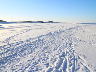 tracks on snowy ice on a winter day