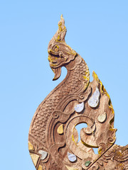 Fototapeta na wymiar Naga at the end of the bargeboard on the gable roof of Wat Ton Kwen temple, Chiang Mai, Thailand