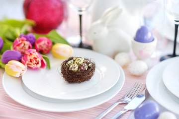 Beautiful table setting with crockery and flowers for Easter celebration