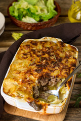 Oven dish potato gratin with minced beef and bechamel sauce