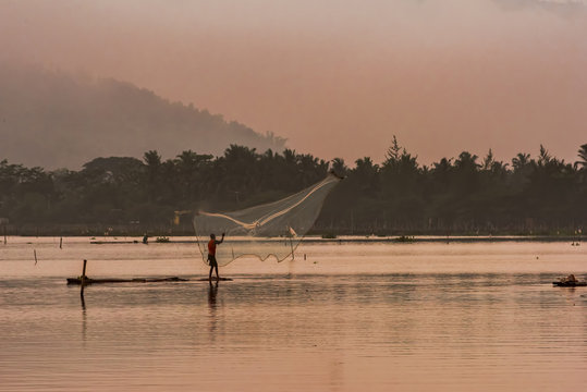 Beautiful landscape and fisherman spreads the web in golden hours of water dam