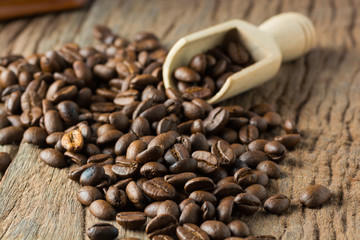 Pile of Fresh Raw Coffee Beans on Wooden Desk Table