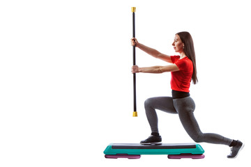 Fitness woman is exercising with the crossbar and stepper.