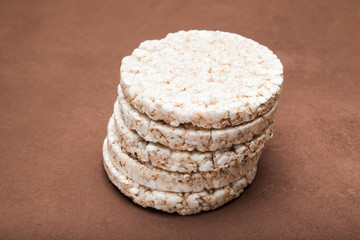 Rice dietary loaves laid out by a pyramid. Brown background.