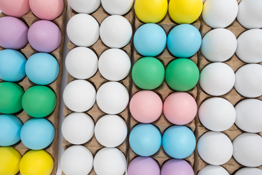 Easter egg festive background: different colored eggs on a table top