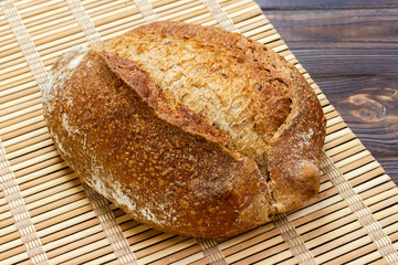 Close up of rustic loaf of bread on wooden table