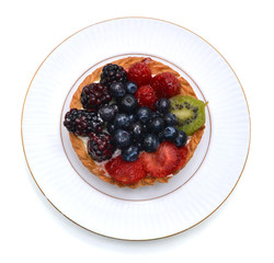 Fresh fruit tart in white plate on white