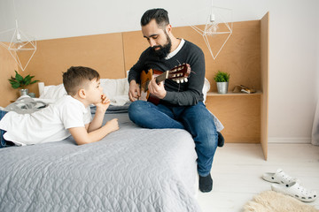 Man with boy in bedroom