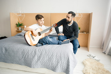 Home guitar lesson in bedroom
