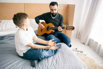 Son and father with guitar