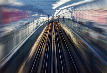 Fast motion zoom effect in a tunnel with train tracks