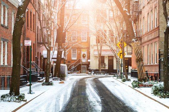 Sunlight shines on snow covered street in Greenwich Village Manhattan New York City