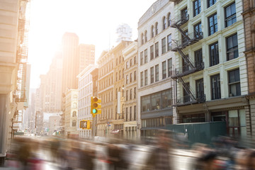 Fototapeta na wymiar Fast paced motion blur of people walking down Broadway in SoHo Manhattan, New York City