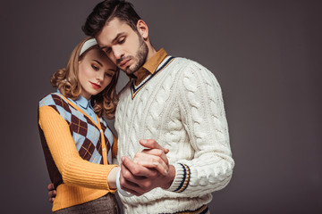 beautiful retro styled couple dancing isolated on grey
