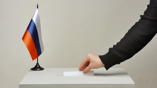 Ballot box with national flag of Russia. Presidential election in 2018. the voter throws the ballot in the ballot box. The camera is fixed