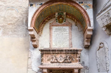 Papier Peint photo Monument Sarcophagus of the Abati - Sarcofago degli Abati - on the external façade of the little church of Sant'Apollinare, Trento, Trentino Alto Adige, Italy