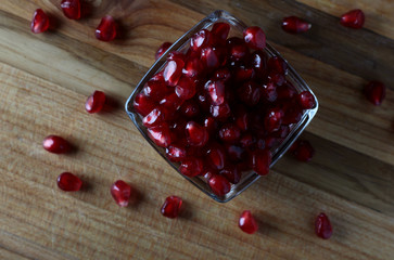still life with juicy pomegranate berries on a dark background