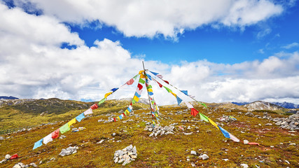 Buddhist prayer flags on the top of a mountain.