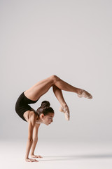 Young gymnast girl stretching and training